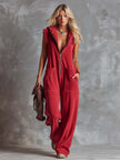 Raspberry red cotton hooded zip-front jumpsuit for women by FJØRNA, featuring a relaxed fit and front zipper detail.