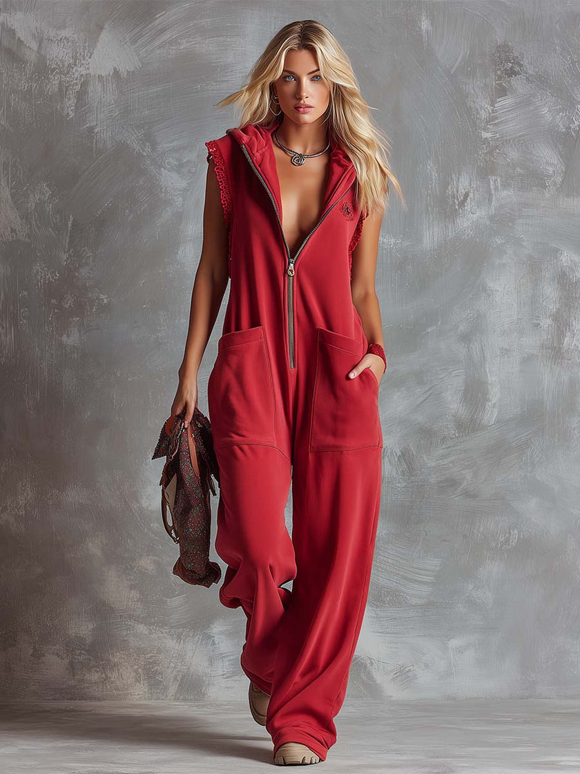 Raspberry red cotton hooded zip-front jumpsuit for women by FJØRNA, featuring a relaxed fit and front zipper detail.