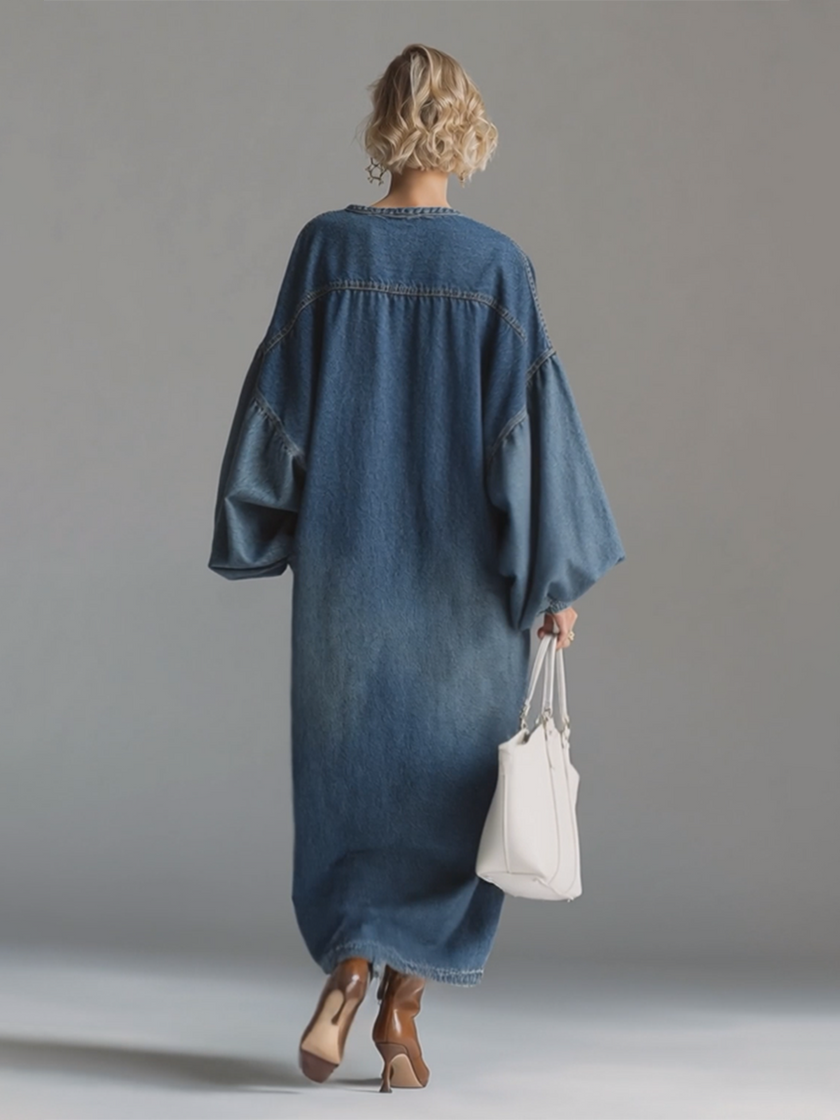 Blue denim maxi dress by FJØRNA with a flowing silhouette, perfect for evening wear, shown on a model.