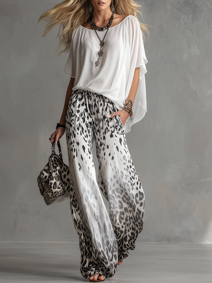 White leopard print chiffon wide-leg trousers for women by FJØRNA, featuring flowy fabric and stylish wide-leg design.