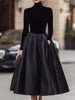 Elegant black velvet and satin midi dress for women by FJØRNA, showcasing a stylish midi dress with luxurious fabric details.
