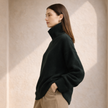 FJØRNA women's wool turtleneck sweater in cozy knit, featuring a fitted silhouette and classic design for cold weather wear.