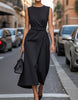 FJØRNA women's midi dress with round neck, sleeveless design, and pleated details, perfect for elegant daytime wear.