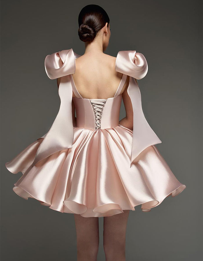 Light pink satin cocktail dress for women by FJØRNA featuring a sweetheart neckline, corset fit, and bow detail.