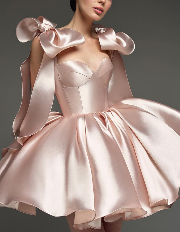 Light pink satin cocktail dress for women with sweetheart neckline, corset style and bow detail by FJØRNA.