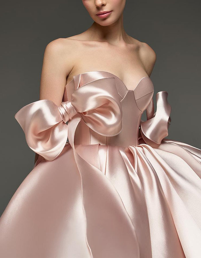 Light pink satin cocktail dress for women with sweetheart neckline, corset bodice, and bow detail by FJØRNA.