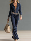 Dark blue knitted hooded zip-up V-neck jumpsuit for women by FJØRNA, featuring a comfortable fit and stylish design.