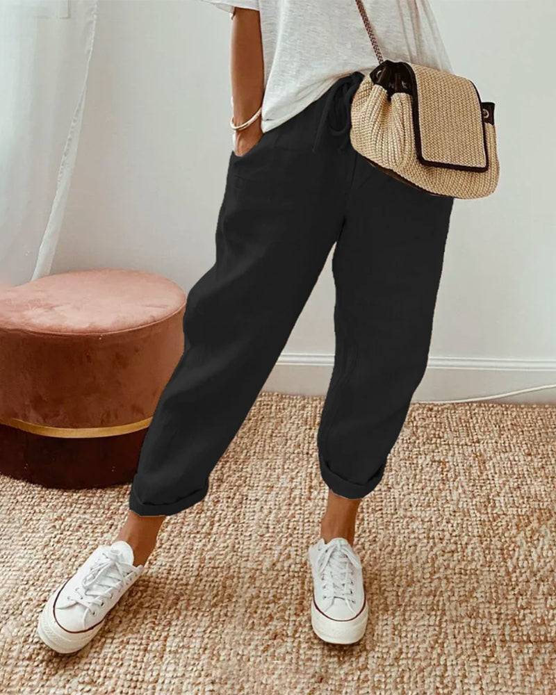 FJØRNA lightweight summer women's trousers with straight leg fit and high waist, shown on a model in a casual setting