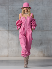 Pink denim strappy tapered long sleeve jumpsuit for women by FJØRNA, featuring a stylish design and tapered pant legs.