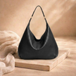Large FJØRNA leather hobo bag for women, showcasing spacious design and stylish brown leather material.