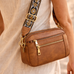 Black FJØRNA leather shoulder bag for women with sleek design, featuring a smooth refined leather finish and adjustable strap.