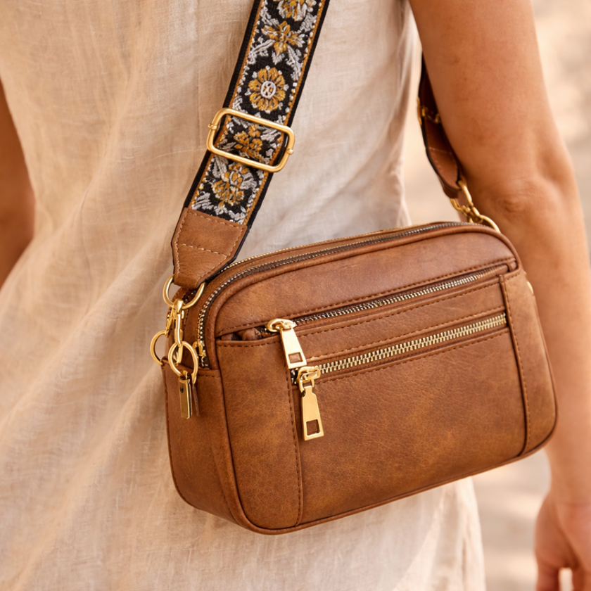 Black FJØRNA leather shoulder bag for women with sleek design, featuring a smooth refined leather finish and adjustable strap.