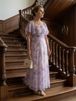 FJØRNA women's summer midi dress with floral pattern, square neckline, and flutter sleeves on a model outdoors.