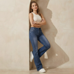 Women's mid-waist stretch flared jeans by FJØRNA, slim fit denim pants with a fashionable flare silhouette.