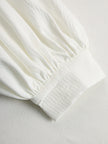Cream textured lantern sleeve two-piece set for women by FJØRNA, featuring pants and a stylish top with lantern sleeves.