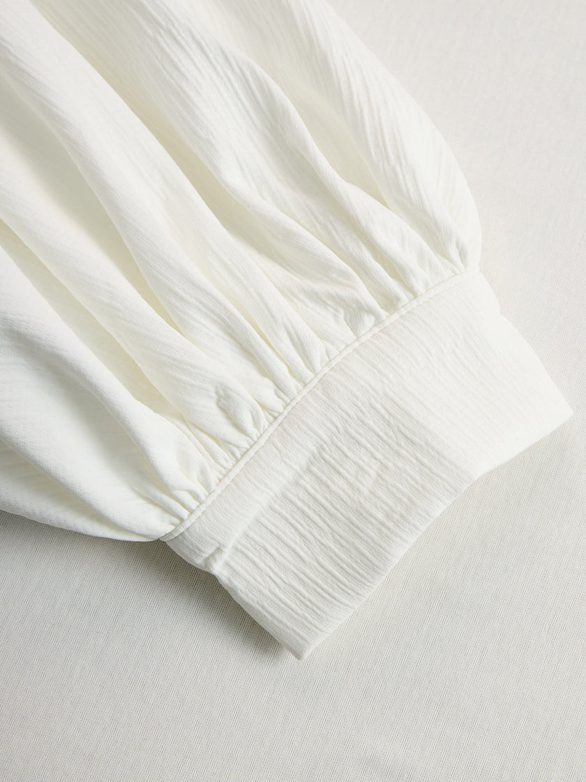 Cream textured lantern sleeve two-piece set for women by FJØRNA, featuring pants and a stylish top with lantern sleeves.