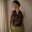 Cream satin cowl neck sleeveless top for women by FJØRNA, featuring a chic mock neck and elegant sleeveless design.