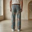 Unisex rose print wide-leg floral denim jeans from FJØRNA, featuring vibrant rose patterns on classic wide-leg pants.