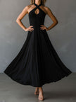 Black FJØRNA halter neck midi dress, elegant evening dress with fitted silhouette and open back, suitable for formal occasions.