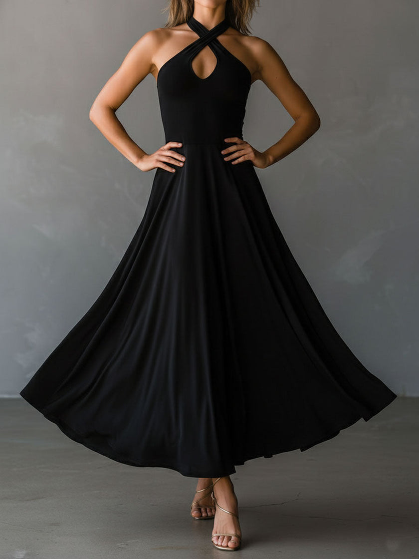 Black FJØRNA halter neck midi dress, elegant evening dress with fitted silhouette and open back, suitable for formal occasions.