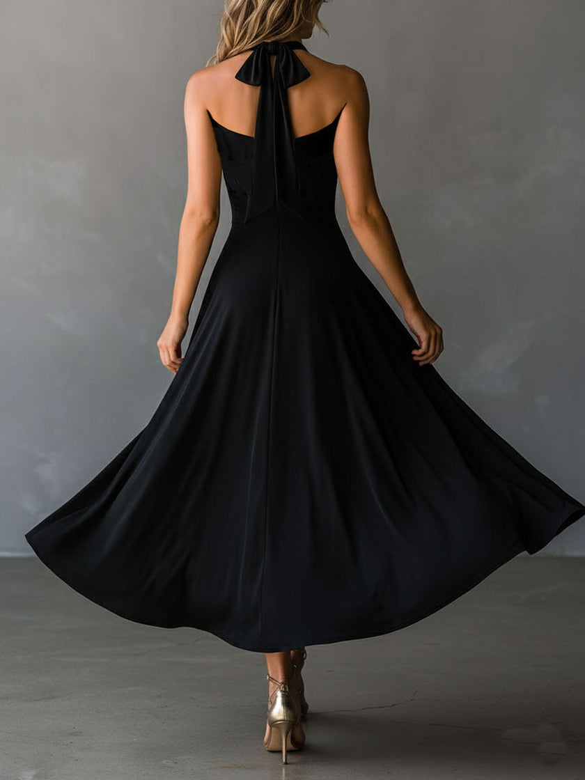 FJØRNA black halter neck midi dress, elegant evening dress with fitted bodice and flowing skirt, perfect for formal occasions.