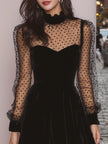 FJØRNA velvet evening dress displayed on a hanger, showcasing its rich fabric and elegant silhouette for formal occasions.