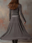 Charcoal knit maxi dress for women by FJØRNA, featuring a flowing silhouette and long sleeves, perfect for casual or elegant wear.
