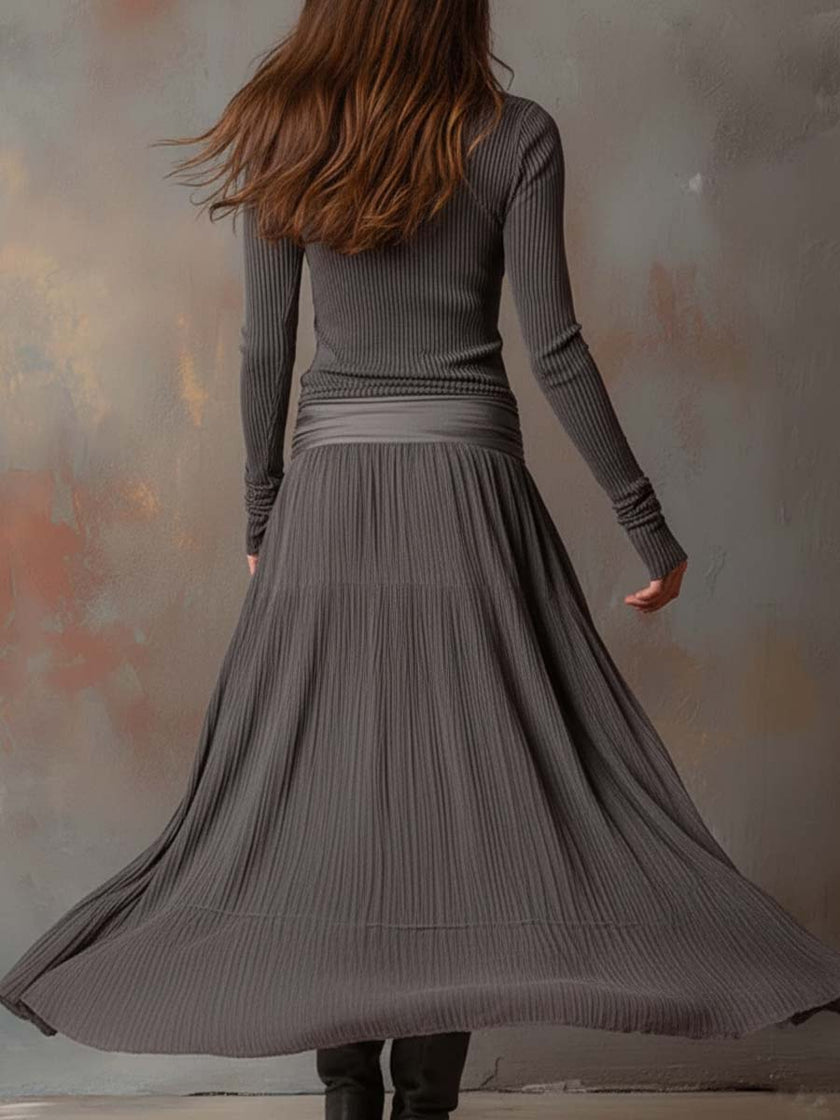 Charcoal knit maxi dress for women by FJØRNA, featuring a flowing silhouette and long sleeves, perfect for casual or elegant wear.