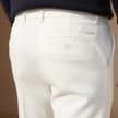 Men's slim fit ankle-length chinos by FJØRNA, shown in dark fabric with classic pockets and tailored fit.
