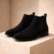 FJØRNA black slip-on Chelsea boots for men, stylish leather shoes with elastic side panels and sleek design.
