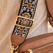 Black FJØRNA leather shoulder bag for women, stylish and refined, with a sleek design and shoulder strap displayed in the image.