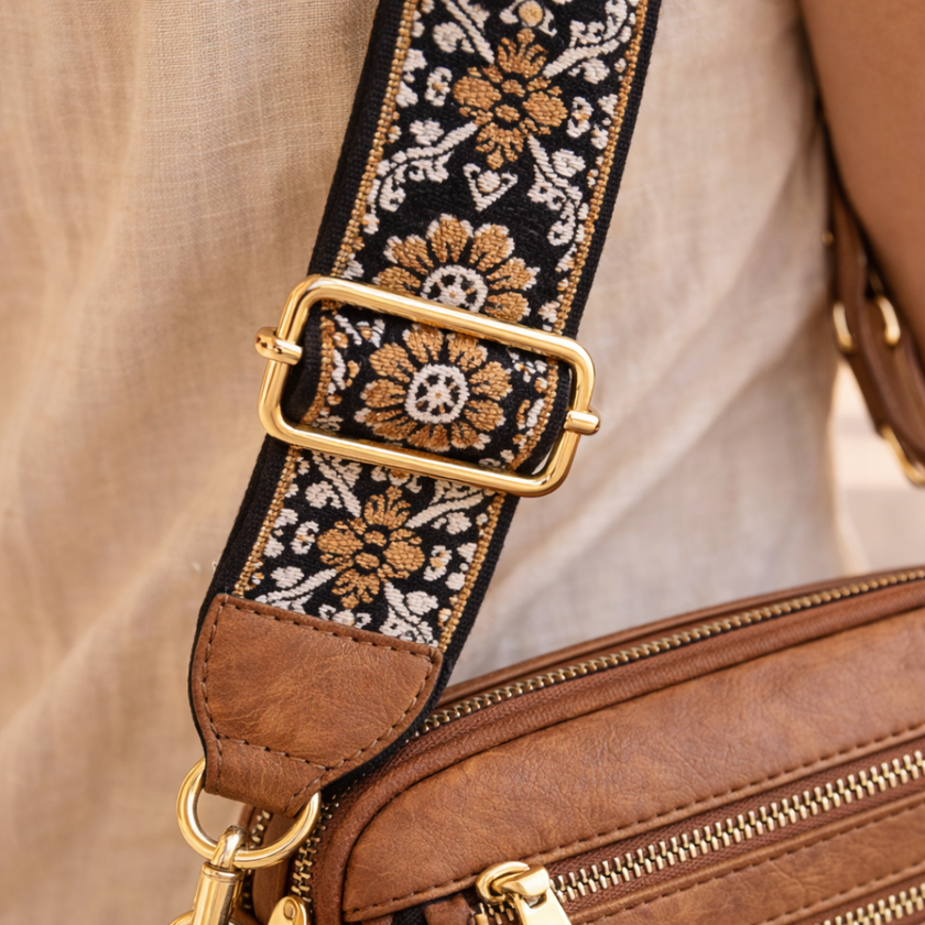 Black FJØRNA leather shoulder bag for women, stylish and refined, with a sleek design and shoulder strap displayed in the image.