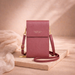 FJØRNA touchscreen crossbody phone bag for women with a compact design, featuring a clear front pocket for easy phone access.