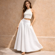 White cotton high-waist maxi skirt by FJØRNA, flowing design with a comfortable fit, perfect for casual or dressy occasions.