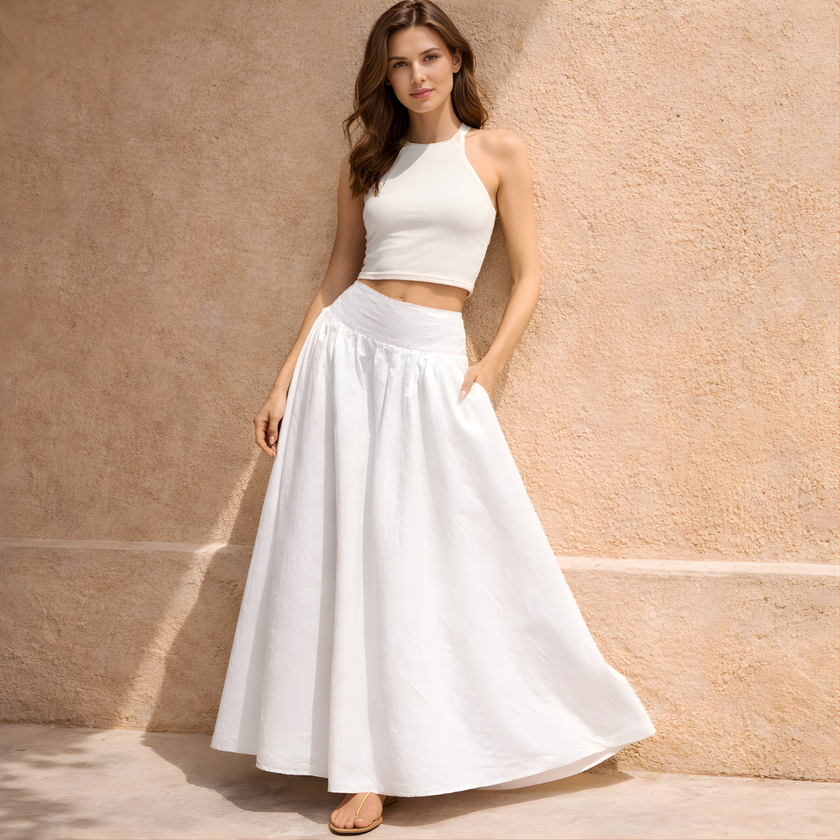 White cotton high-waist maxi skirt by FJØRNA, flowing design with a comfortable fit, perfect for casual or dressy occasions.