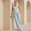 Women's FJØRNA criss-cross waist wide-leg trousers, loose pull-on pants with a relaxed fit, shown in a casual style.