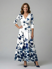 FJØRNA women's floral summer maxi dress with V-neck wrap design, flowing fabric and vibrant floral pattern.