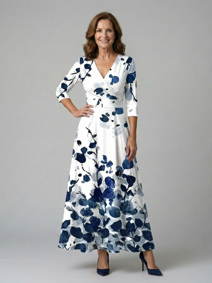 FJØRNA women's floral summer maxi dress with V-neck wrap design, flowing fabric and vibrant floral pattern.