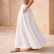 FJØRNA high-waist white A-line maxi skirt for women, flowing fabric, full-length design, elegant and versatile for various outfits.