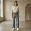 Unisex rose print wide-leg floral denim jeans by FJØRNA, showing the colorful rose pattern on the wide-leg pants for men.