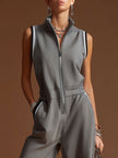 Dark grey FJØRNA women's sleeveless jumpsuit with zip-up front, made of cotton blend fabric, styled as casual pants.