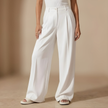Women's high-waist wide-leg tailored trousers by FJØRNA, loose pull-on pants shown in a stylish, relaxed fit.