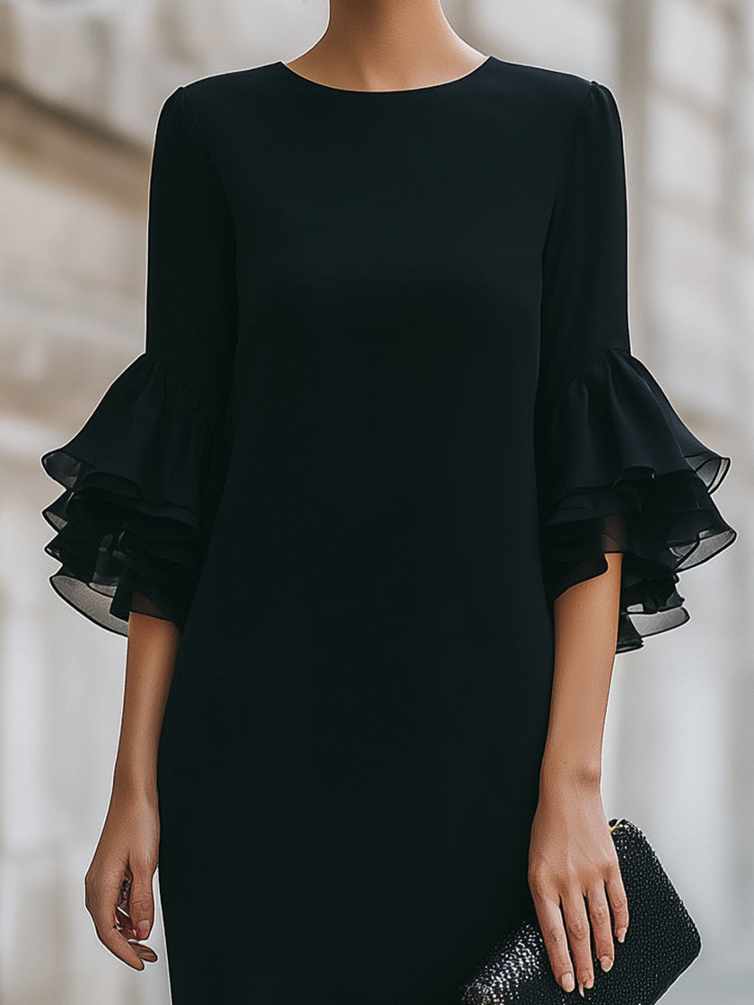 FJØRNA black ruffled sheer sleeve midi dress with elegant cocktail style, featuring flowy fabric and stylish ruffle details.