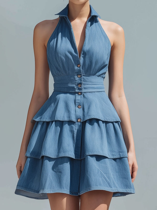 Blue FJØRNA halter-neck tiered ruffle denim mini dress with ruffled details and a fitted silhouette, perfect for casual summer wear.