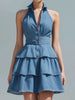 Blue FJØRNA halter-neck tiered ruffle denim mini dress with ruffled details and a fitted silhouette, perfect for casual summer wear.