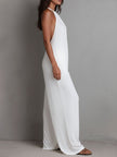 White pleated halter neck wide-leg resort jumpsuit for women by FJØRNA, featuring stylish pleats and a relaxed fit.