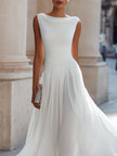 FJØRNA sleeveless midi dress with draped neckline and pleated design, perfect for wedding guest occasions.