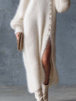 White knit V-neck midi dress for women by FJØRNA, featuring a fitted V-neckline and mid-length hem.