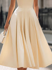 Cream sleeveless turtleneck pleated midi dress by FJØRNA, perfect for wedding guests, featuring elegant design and flowing fabric.