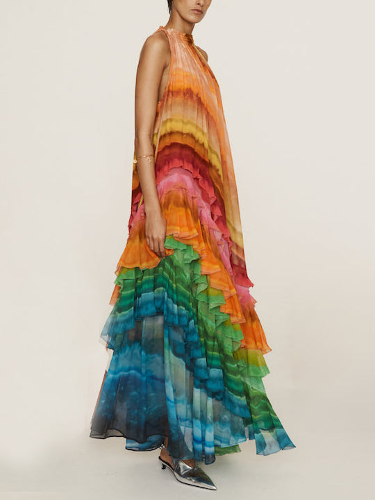 Colorful print ruffle maxi dress for women by FJØRNA, perfect for summer, featuring vibrant patterns and flowing fabric.